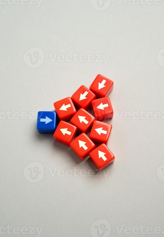 Blue arrow versus multiple red arrows. To endure the strongest resistance. Confronting superior forces. Perseverance and determination. Leadership qualities and faith in your cause. photo