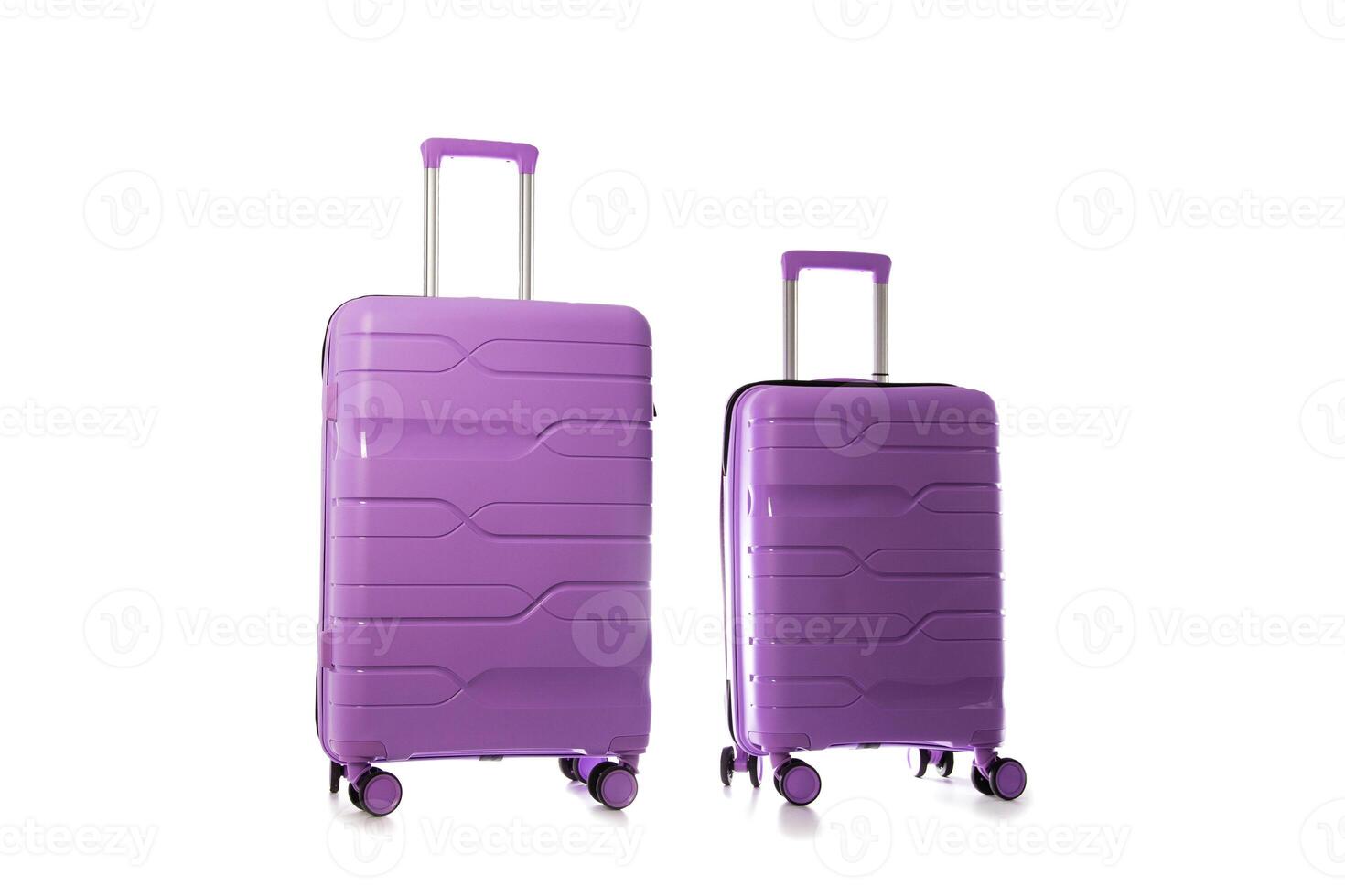 Set of polypropylene purple suitcases on a white background, isolate, close-up photo