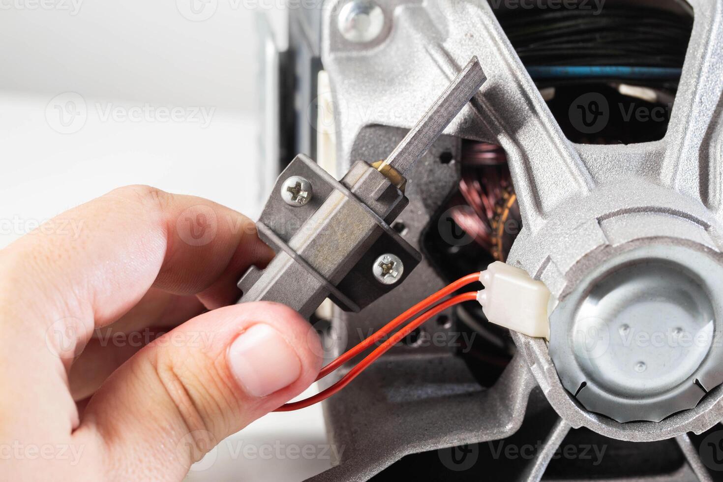Replacing graphite electric motor brushes, close-up, industry. Copy space for text photo
