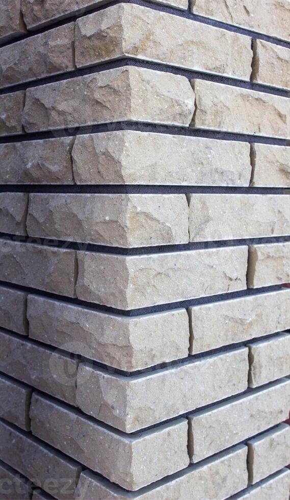 Modern brick column with brown and gray bricks, designer, texture, background, close-up, abstract photo