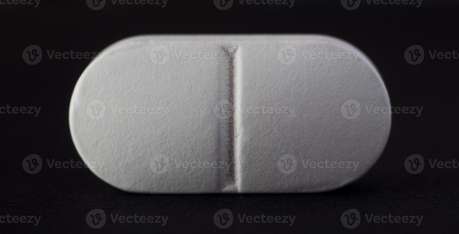 Tablet on a black background, close-up, macro photo