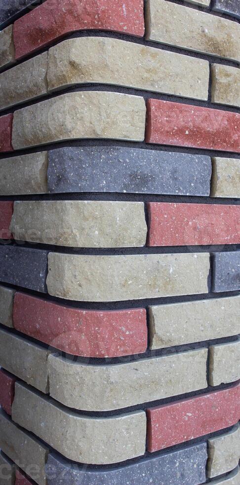 Modern multicolored brick column, background texture, close-up photo