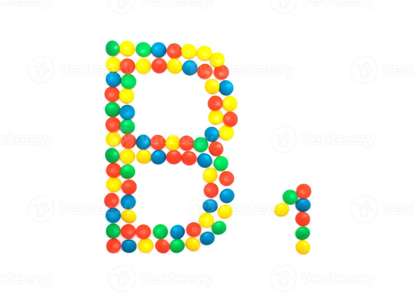 Multi-colored vitamins pills that are lined with the letter Vitamin group B1, cloes-up photo