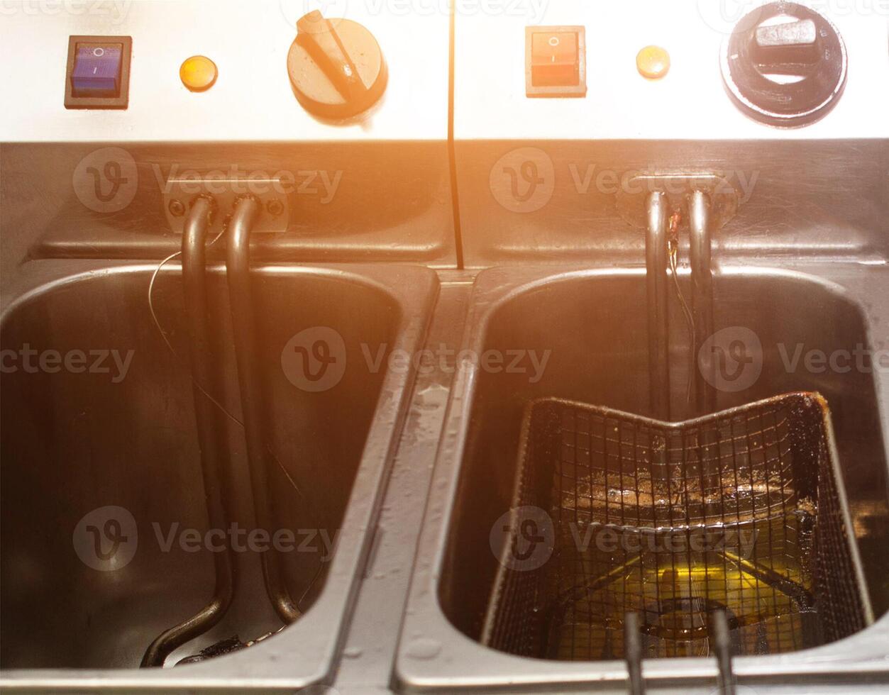 Double deep fryer for cooking french fries, on rustic and slices of potatoes, kitchen, close-up photo