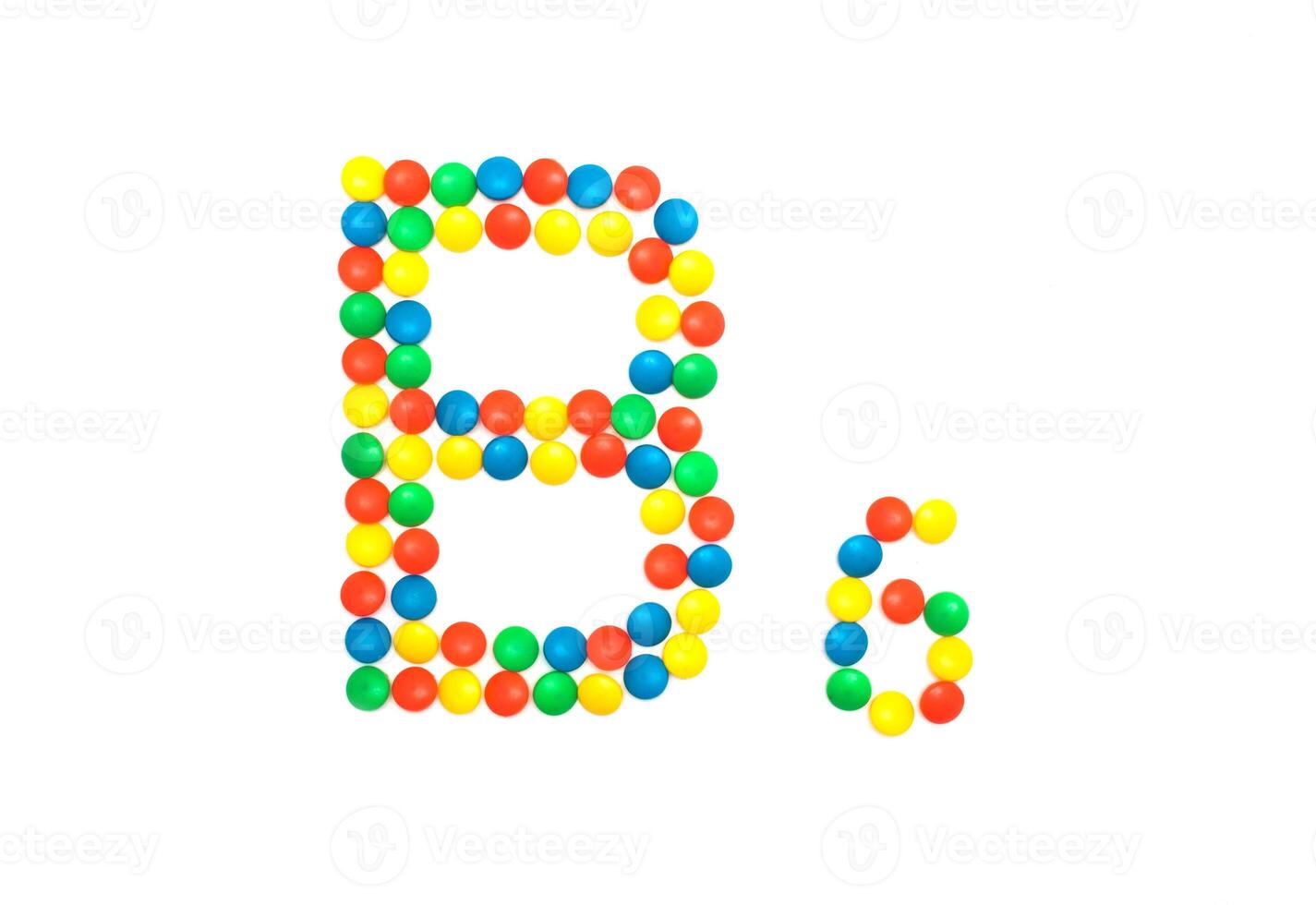 Multi-colored vitamins pills that are lined with the letter Vitamin group B6, close-up photo