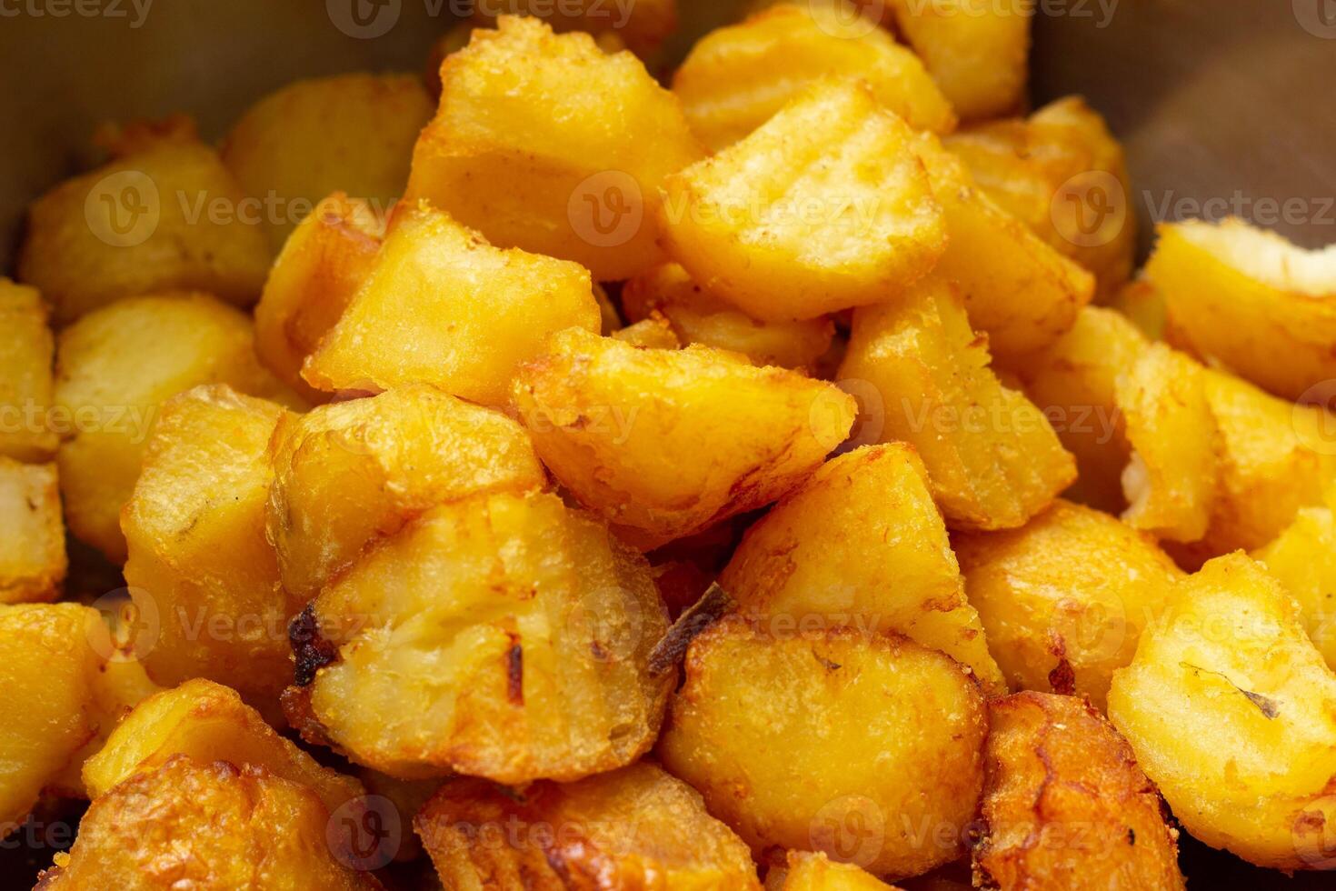 Fried potatoes with a golden crust in a deep fryer, close-up. junk food, spud photo