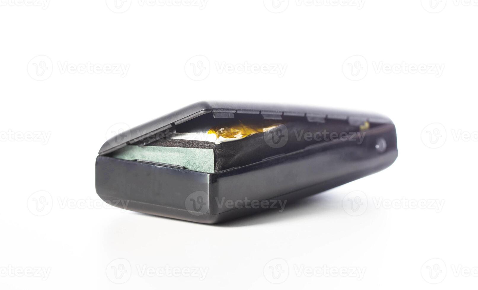 Bloated black power bank on a white background, isolate. Danger of power bank explosion, close-up photo