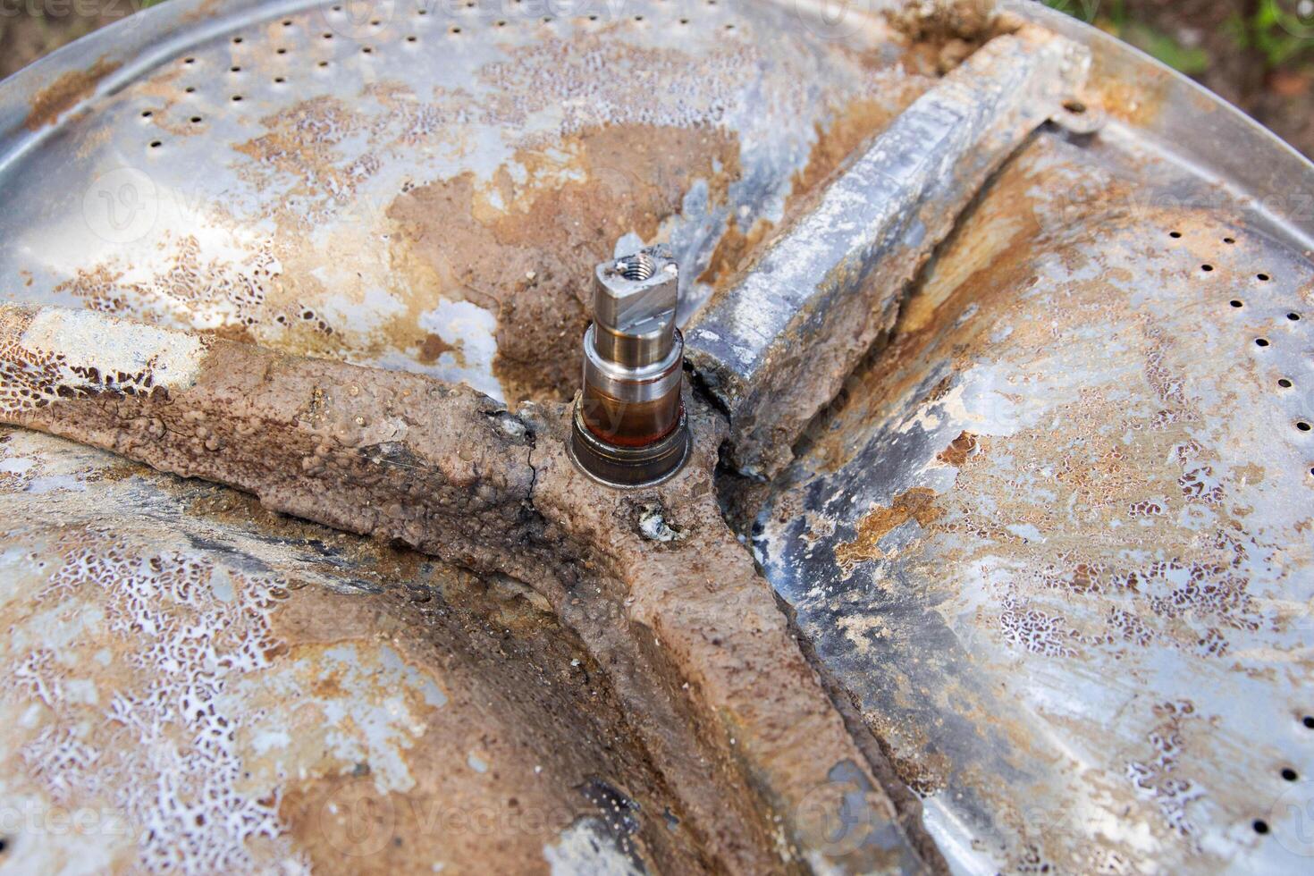 Broken crosspiece in the washing machine drum. Repair and replacement of the cross, industry, close-up photo