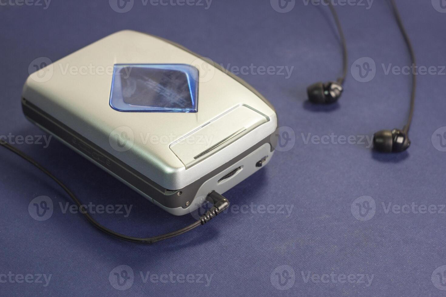 Cassette audio player and headphones on a blue background photo