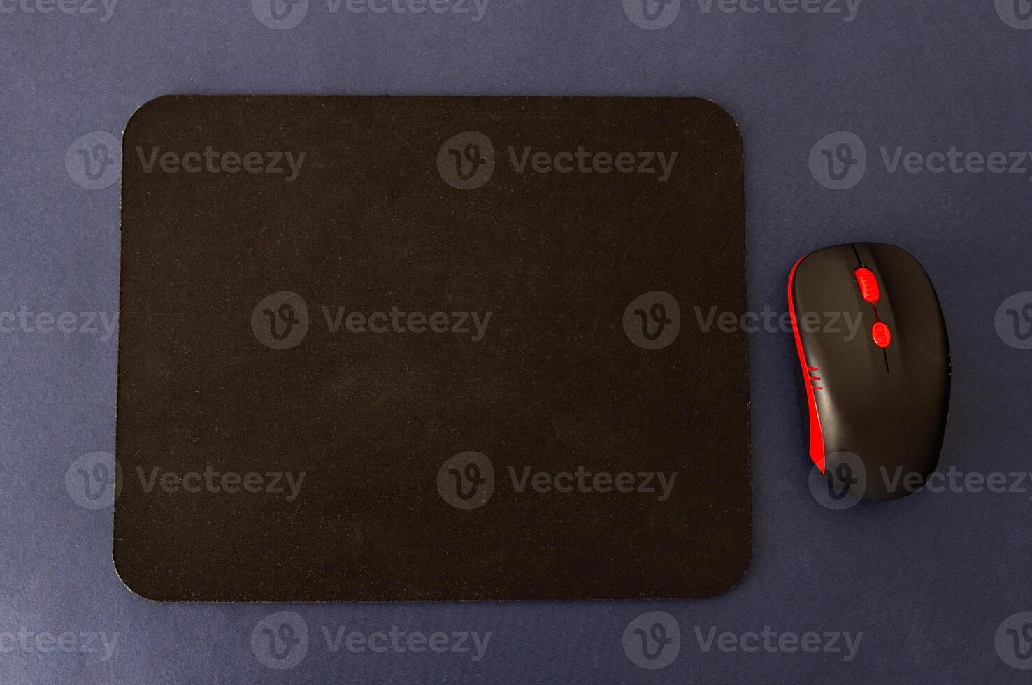 Computer rug and mouse on a blue background, black computer mat photo