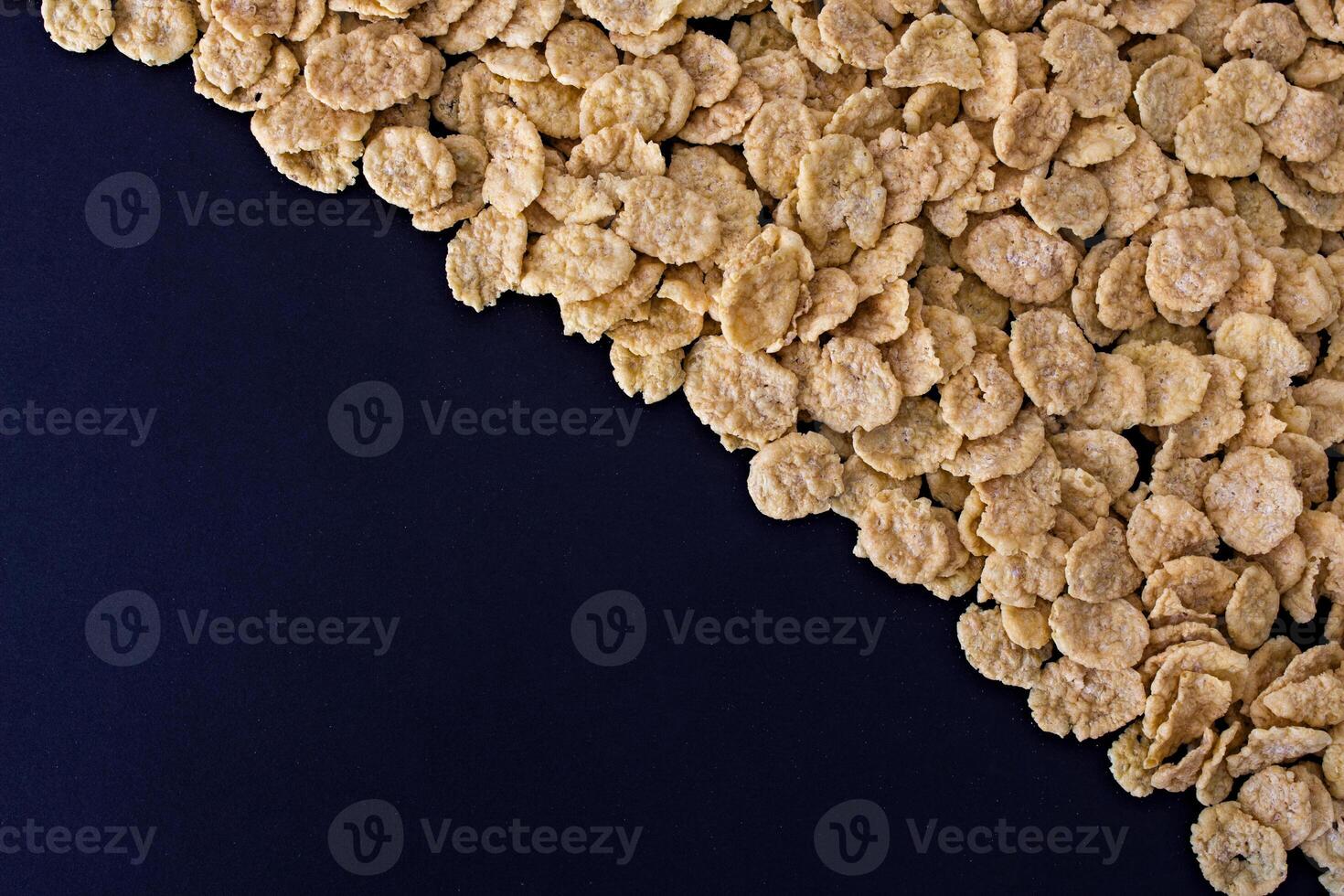 Corn flakes on a black background photo