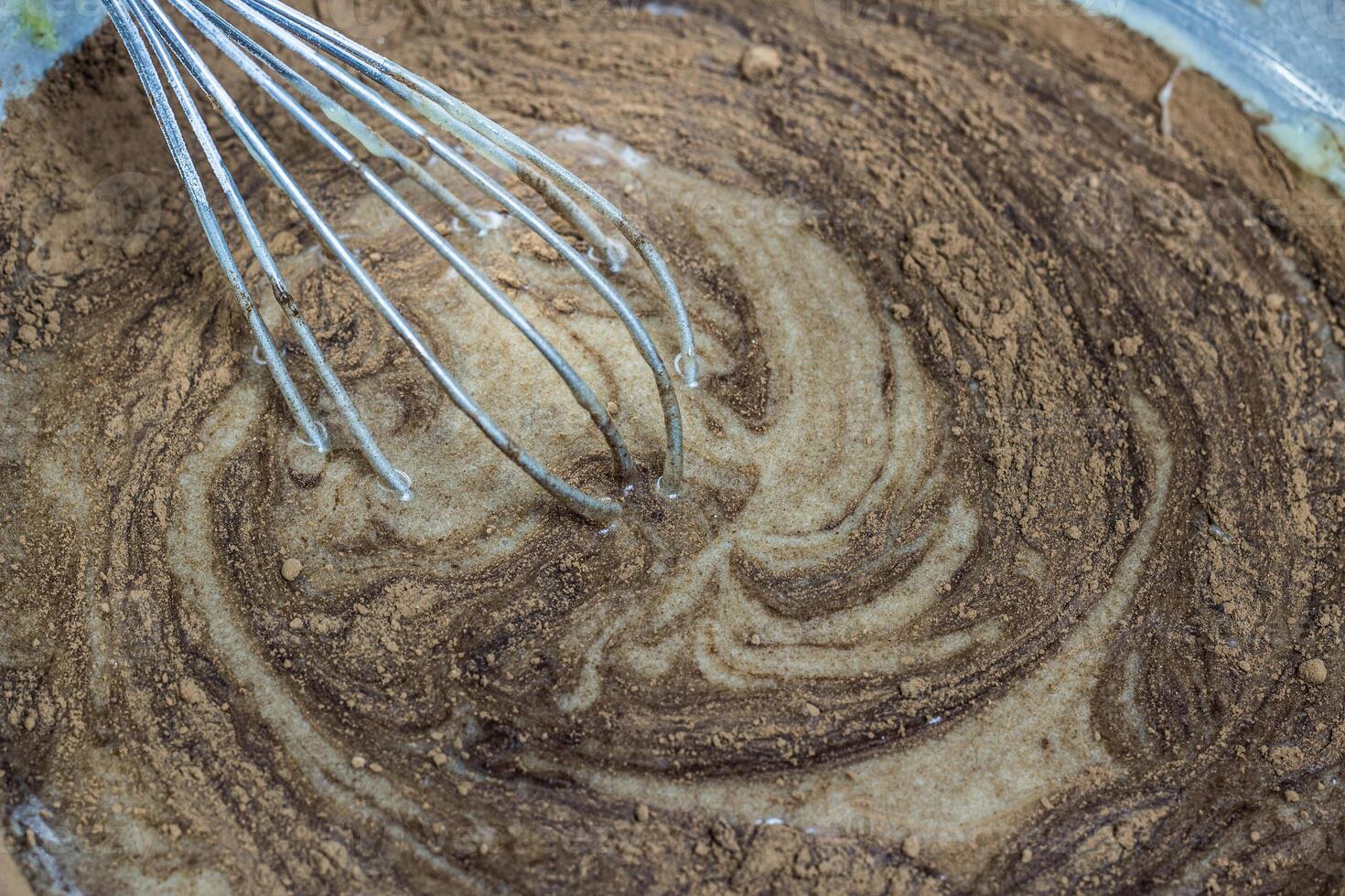 Preparation of cake, cocoa with milk and flour, whisk for whipping photo