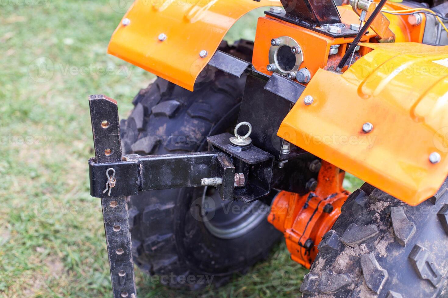 Adjustment of the coupling and attachments in a multifunctional motor cultivator for cottages. Close-up photo