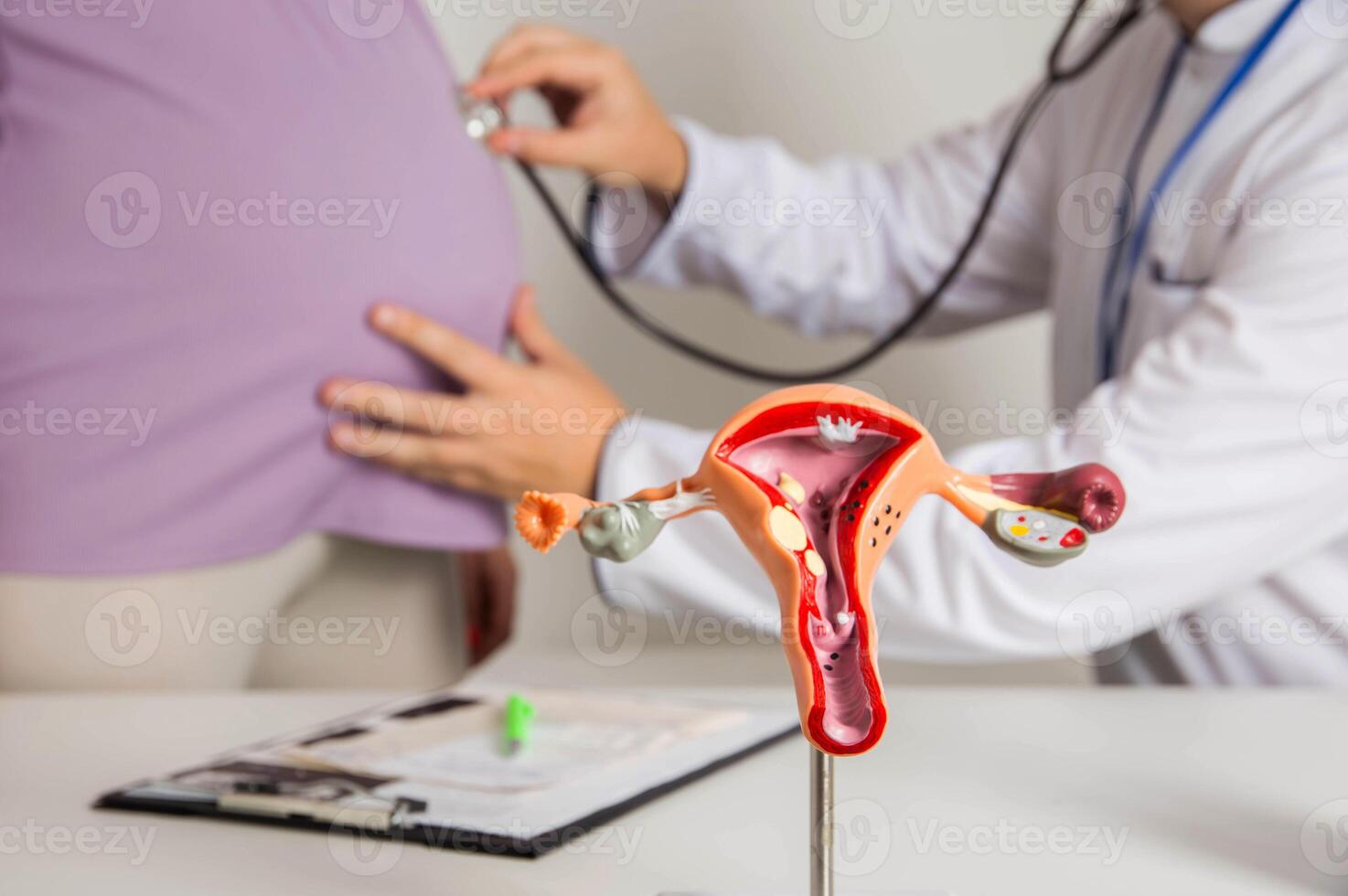Doctor gynecologist listens to the belly of a pregnant girl through a stethoscope. The concept of tracking the movement of the fetus in the womb. Fetal movement test photo