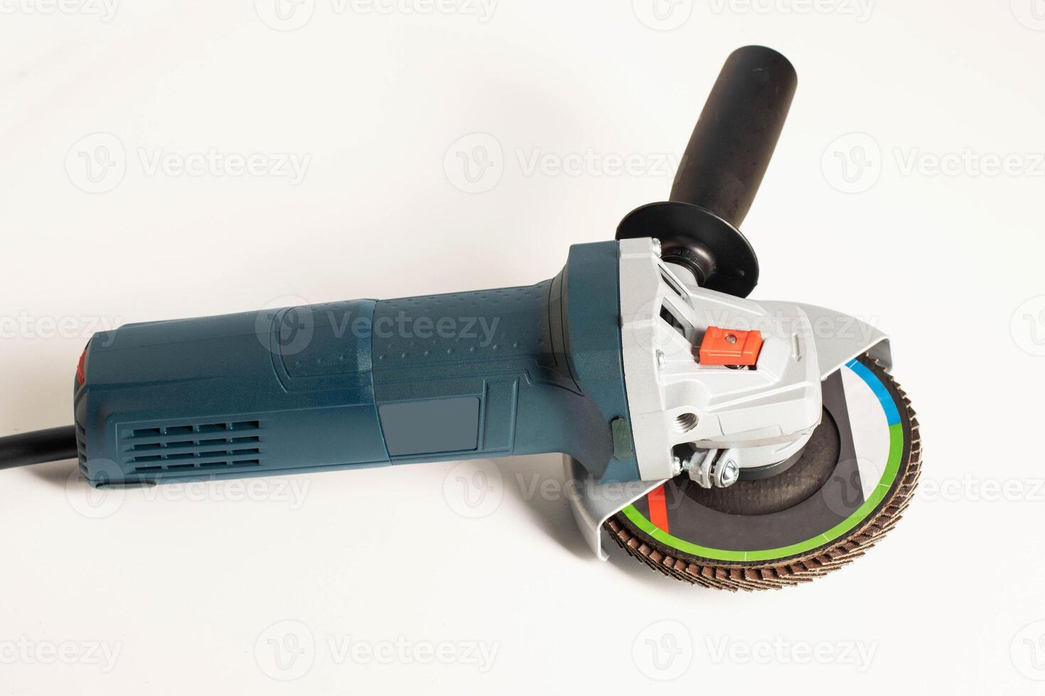Modern professional angle grinder with a flap wheel on a white background. Power tool for work. Sanding wood and metal. photo