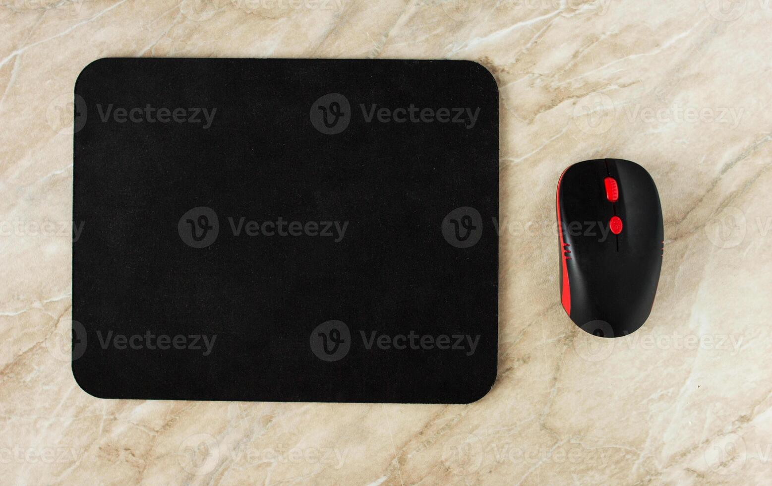 Computer mat and computer mouse on a marble table, close-up, black computer mat photo