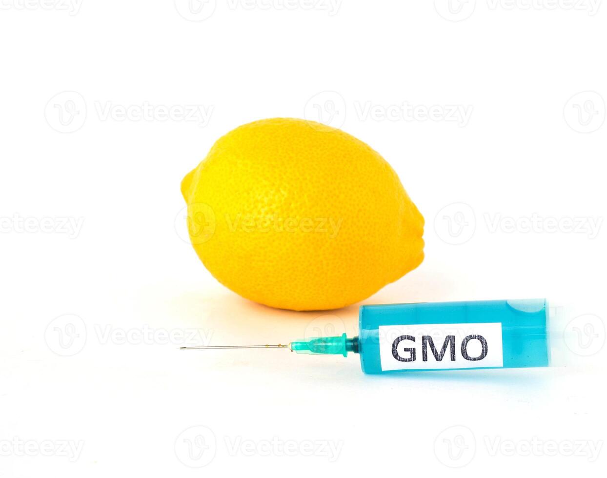 lemon on white background next to which is a syringe with gmo and nitrates, close-up, genetically modified organism photo