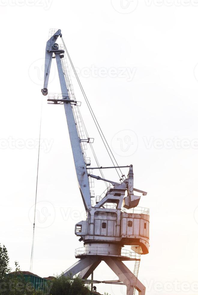Large port crane with bucket for loading, unloading photo