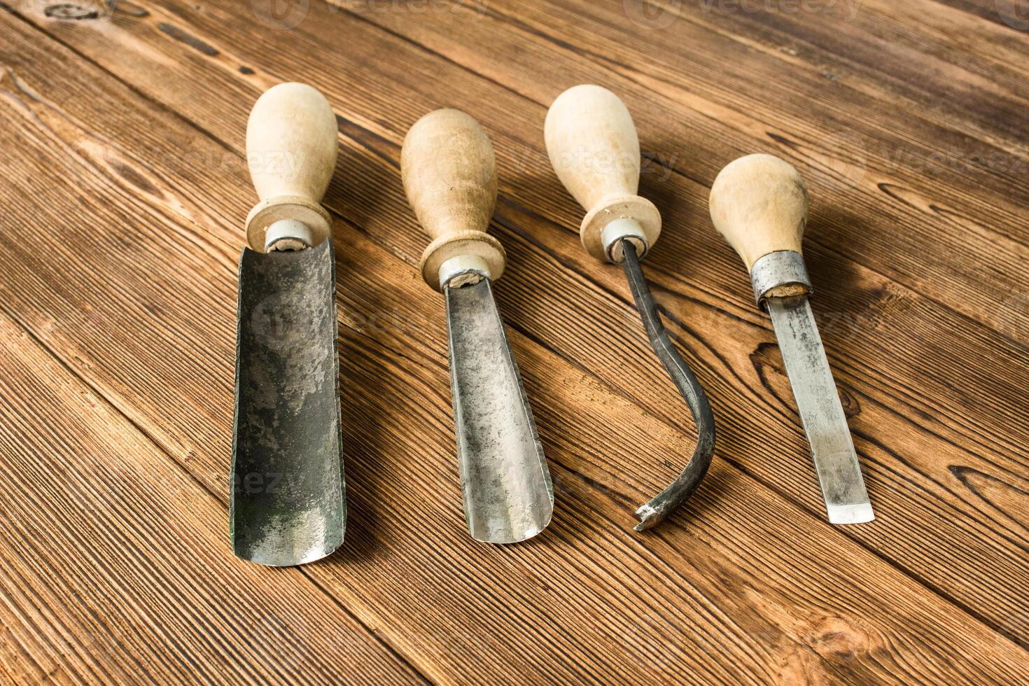 Cutters for wood carving, on a wooden background, close-up, cutting tool photo