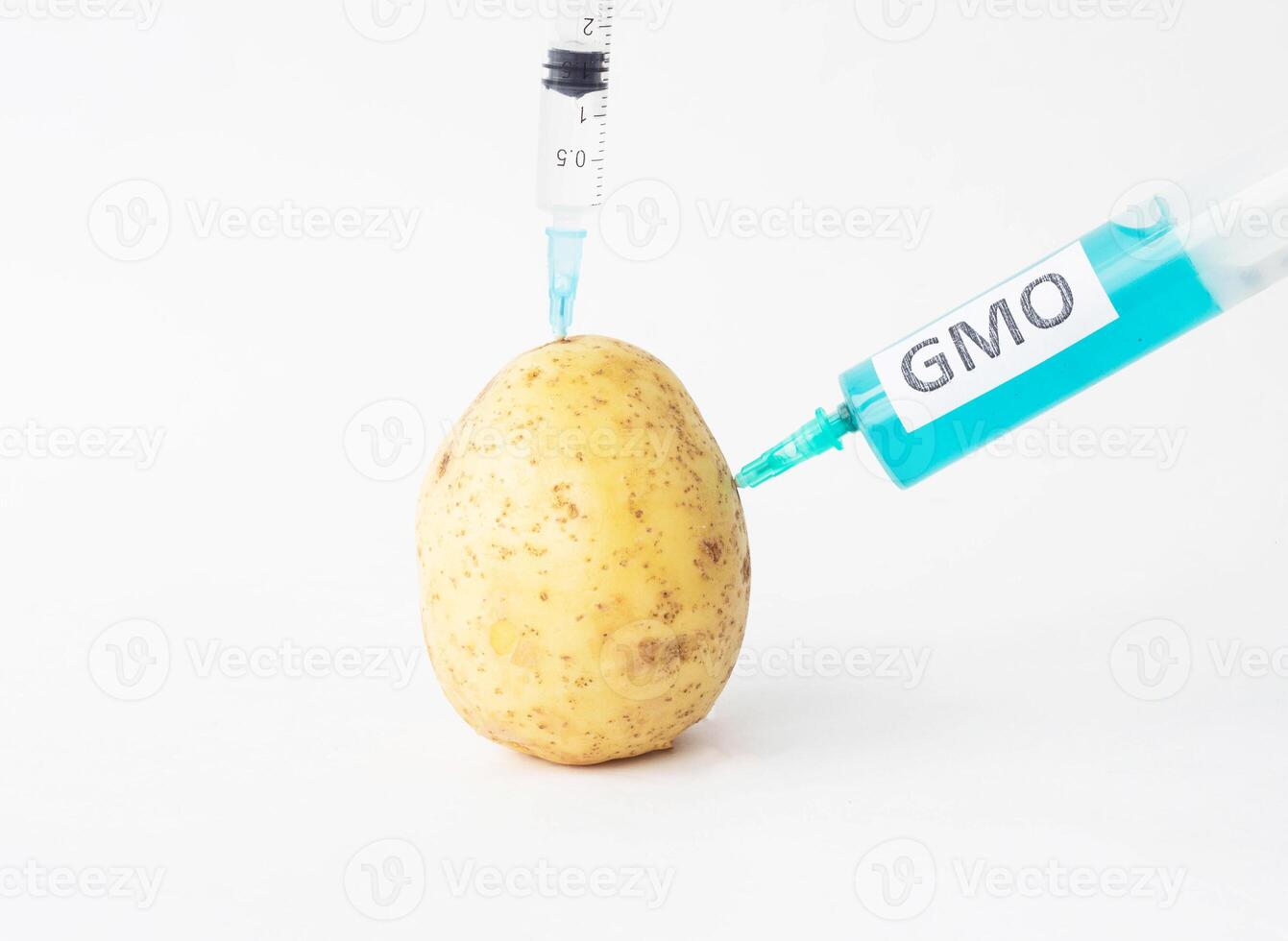 Potatoes on a white background in which of the syringe to the gmo and nitrates, close-up, genetically modified organism photo