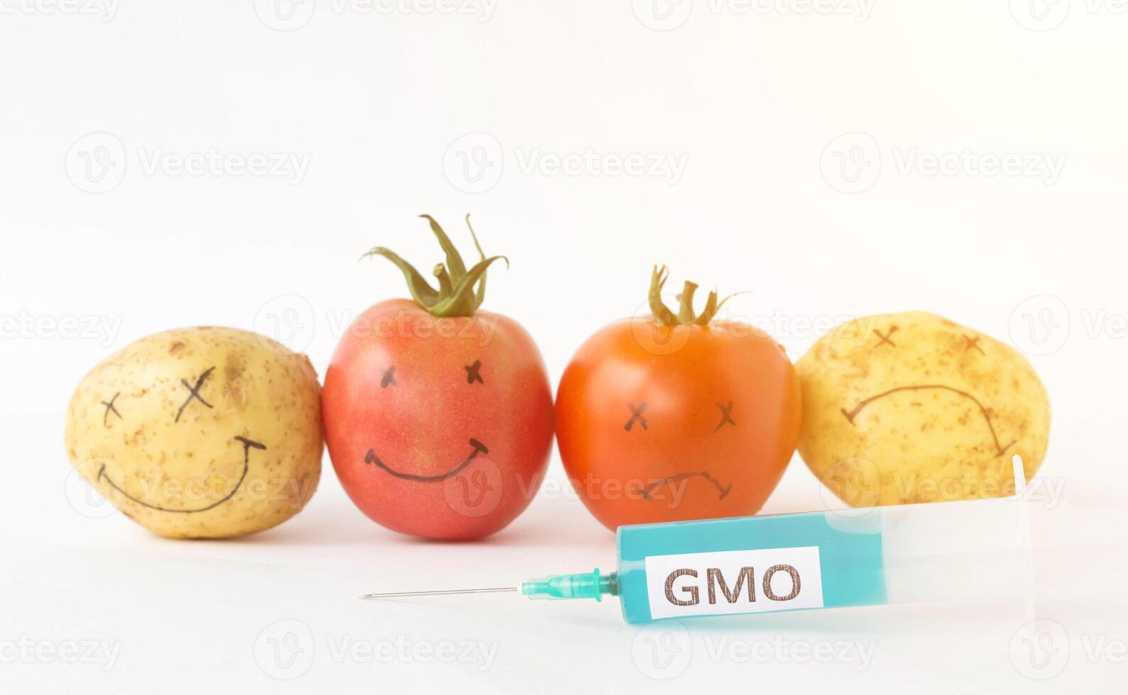 Vegetables on a white background potatoes and tomatoes with nitrates and gmo, syringe, close-up, genetically modified organism photo