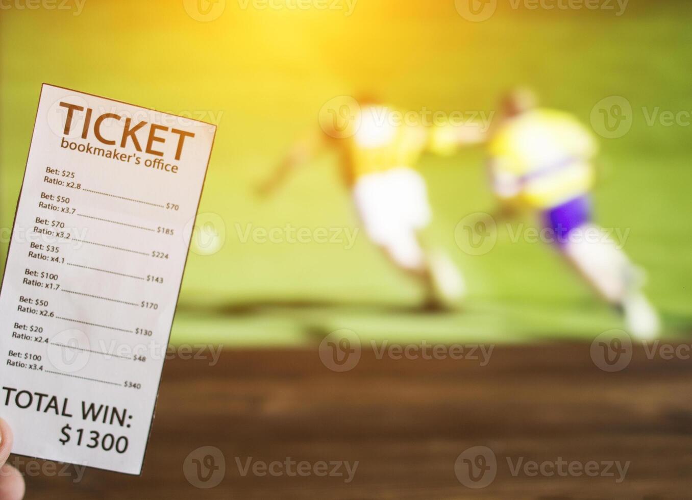 Bookmaker ticket on the background of the TV on which the sport is shown in the game of hurling, sports betting, bookmaker photo