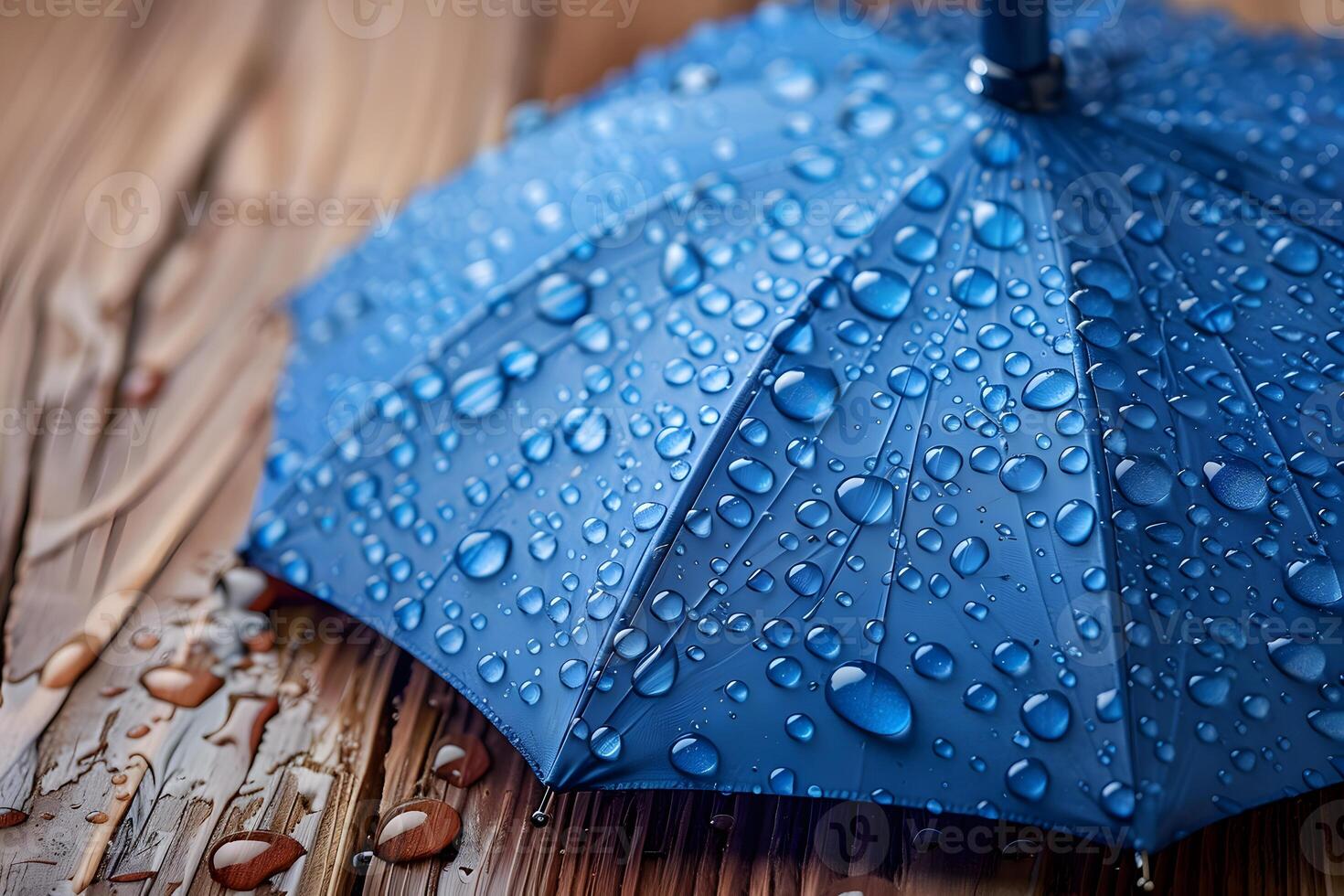 Blue Umbrella with Raindrops on Wooden Surface - Weather and Rain Concept for Stock Use photo