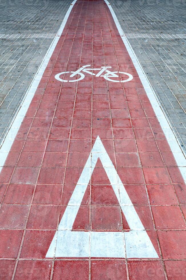Bicycle Lane Marking With a Red Pathway and Warning Symbol for Cyclists in an Urban Area photo