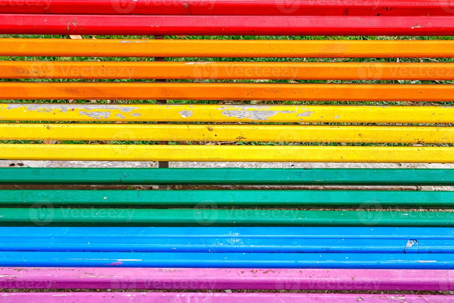 Colorful Wooden Slats Create a Vibrant Bench Design in a Sunny Park Setting photo