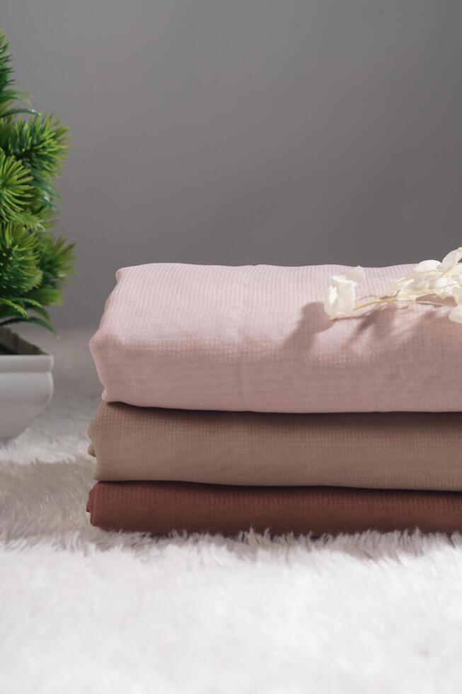 Pile of hijabs in soft colors isolated on a white background. Hijab mockup and high resolution photos. photo