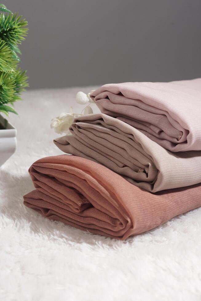 Pile of hijabs in soft colors isolated on a white background. Hijab mockup and high resolution photos. photo