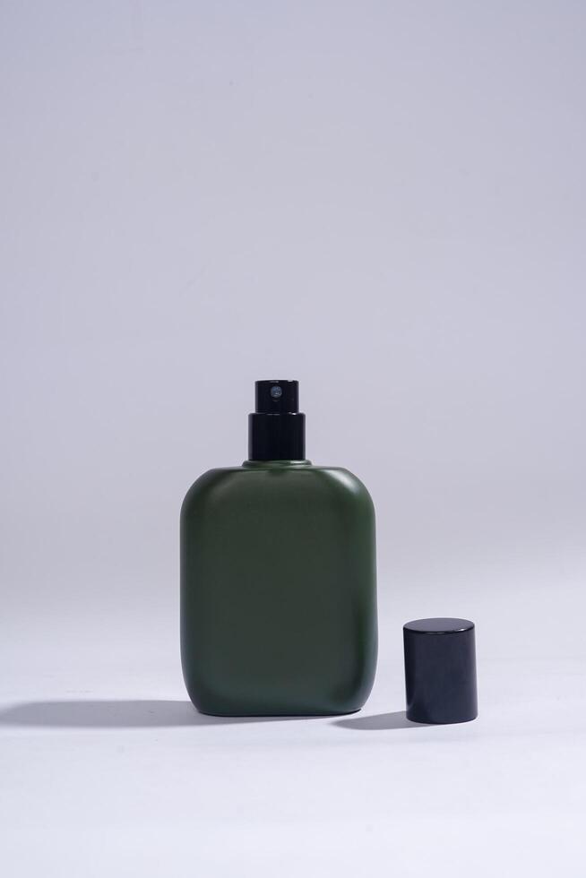 Perfume bottle with black spray on white background. High resolution photo. photo