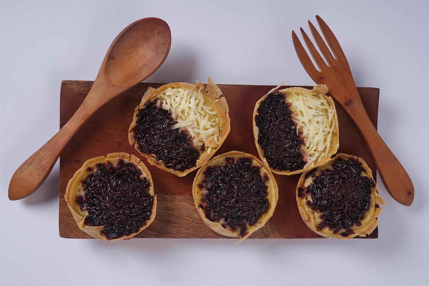 Martabak mini or terang bulan mini is Indonesian popular street food, made from flour, egg, yeast, topped with cheese or chocolate. Mini sweet martabak isolated on white background. photo