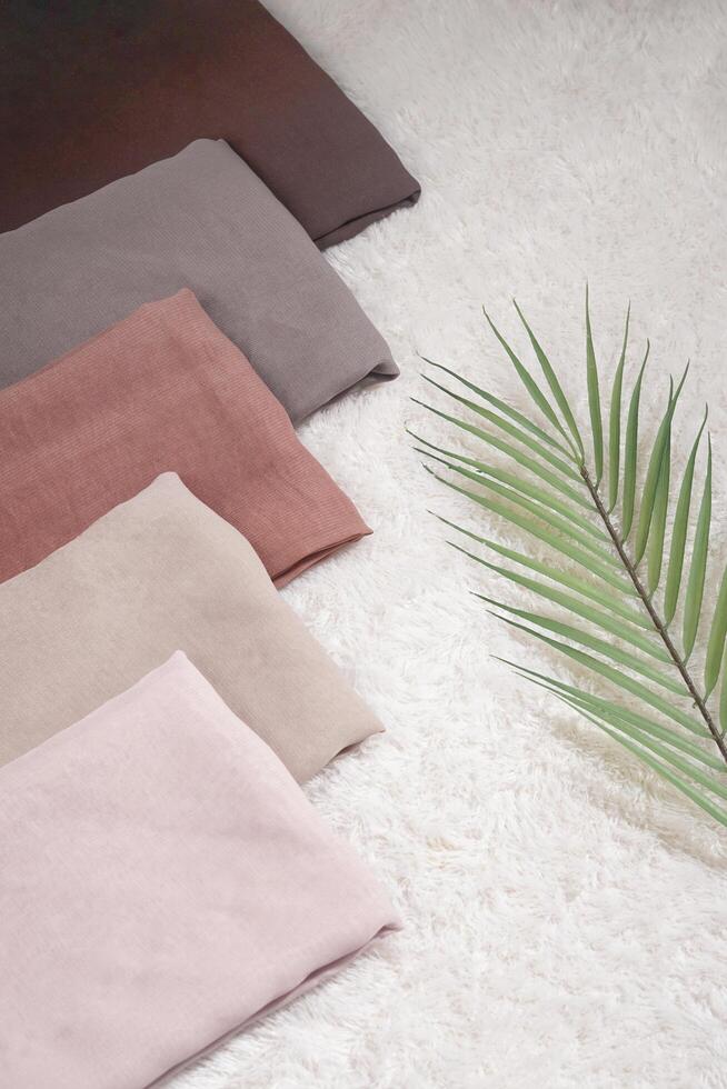 Pile of hijabs in soft colors isolated on a white background. Hijab mockup and high resolution photos. photo