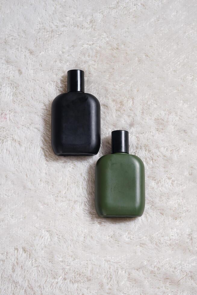 Perfume bottle with black spray on white background. High resolution photo. photo