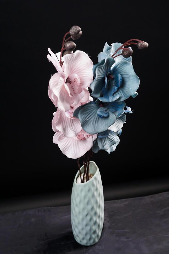 Pink and grey spring flowers in a vase on black background. High resolution photo. Selective focus. photo