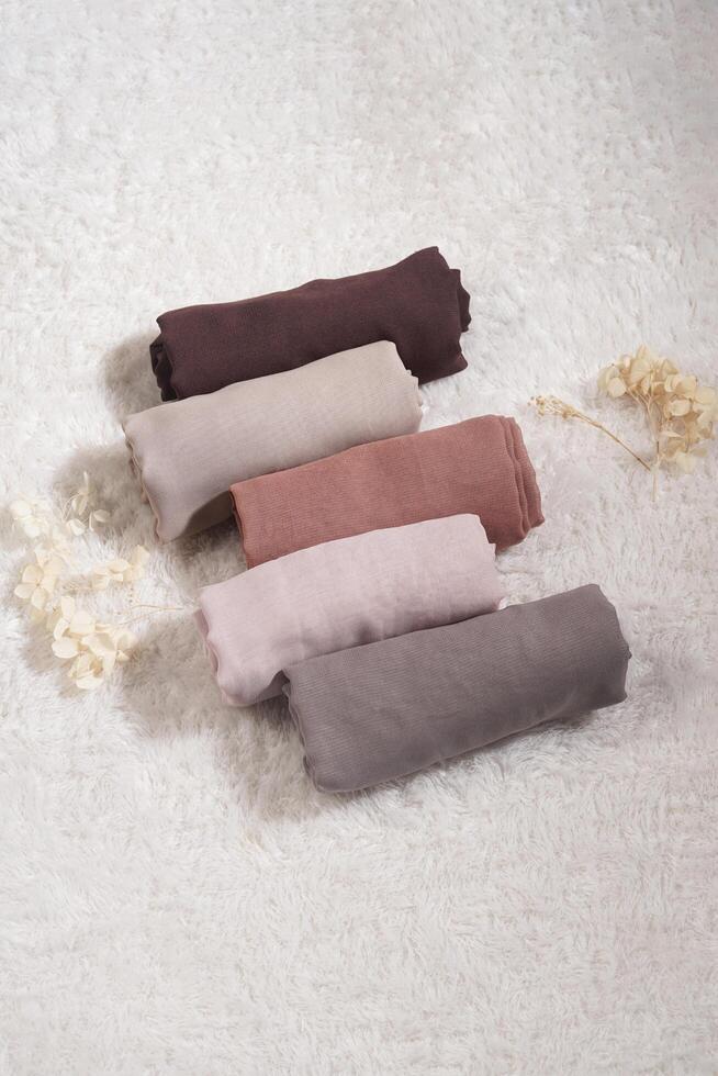 A rolled hijab in soft colors isolated on a white background. Hijab mockup and high resolution photos. photo