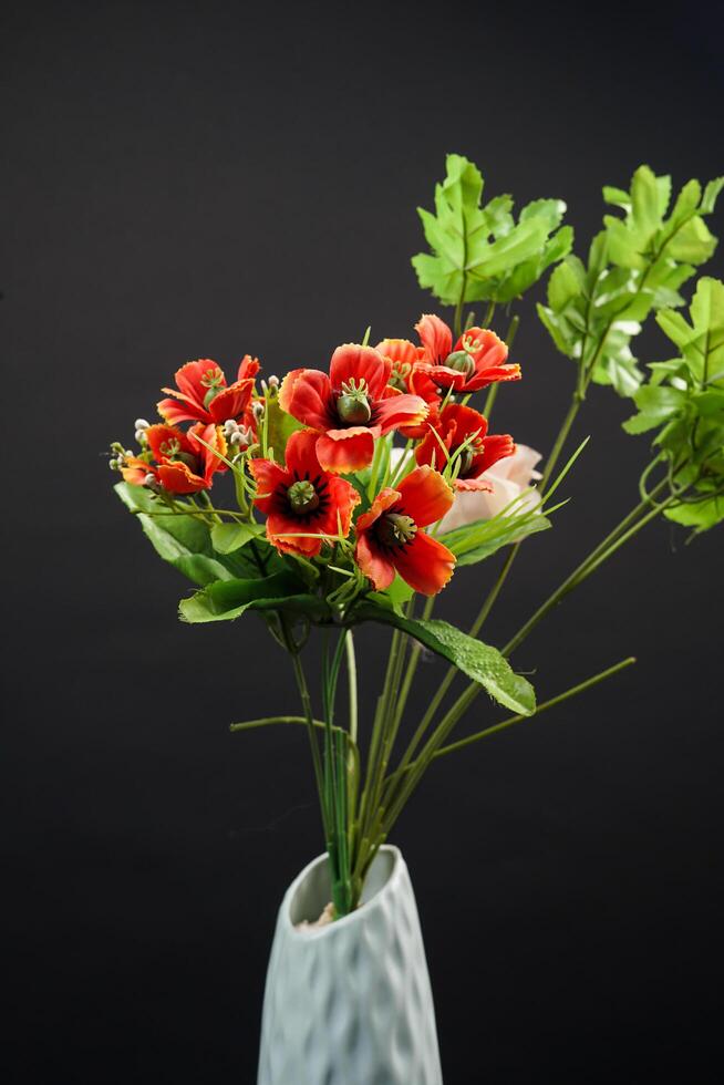 Red and white spring flowers in a vase on black background. High resolution photo. Selective focus. photo