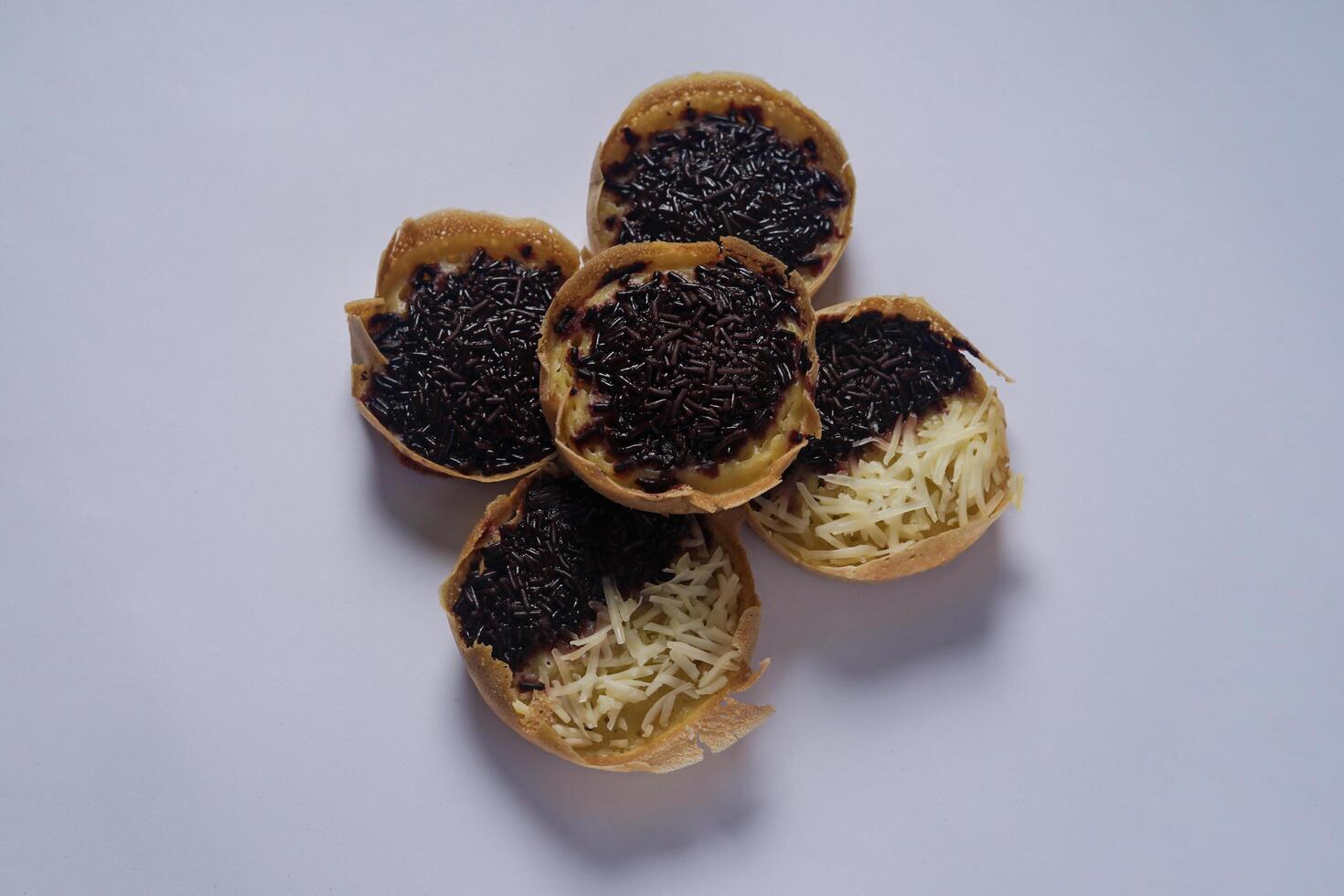 Martabak mini or terang bulan mini is Indonesian popular street food, made from flour, egg, yeast, topped with cheese or chocolate. Mini sweet martabak isolated on white background. photo