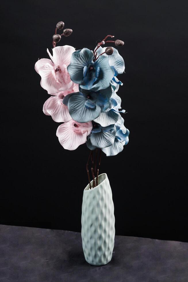 Pink and grey spring flowers in a vase on black background. High resolution photo. Selective focus. photo