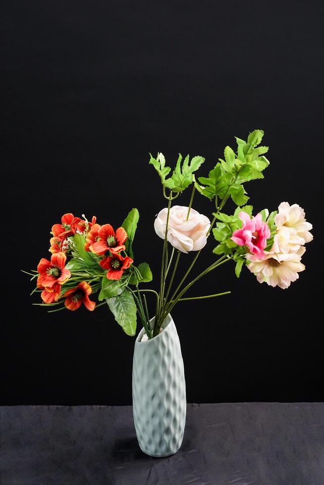 Red and white spring flowers in a vase on black background. High resolution photo. Selective focus. photo