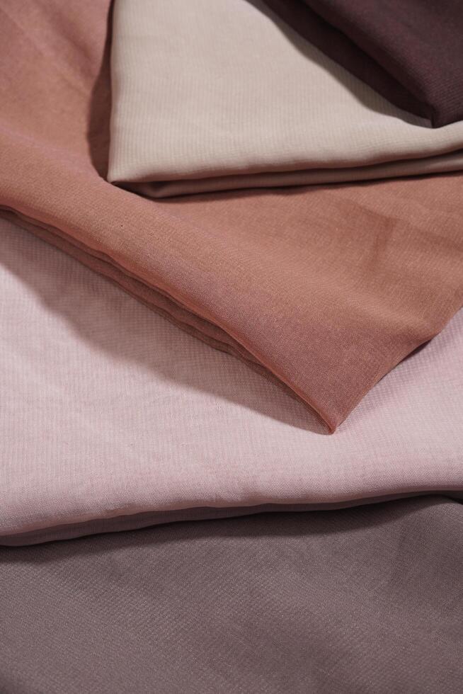 Pile of hijabs in soft colors isolated on a white background. Hijab mockup and high resolution photos. photo