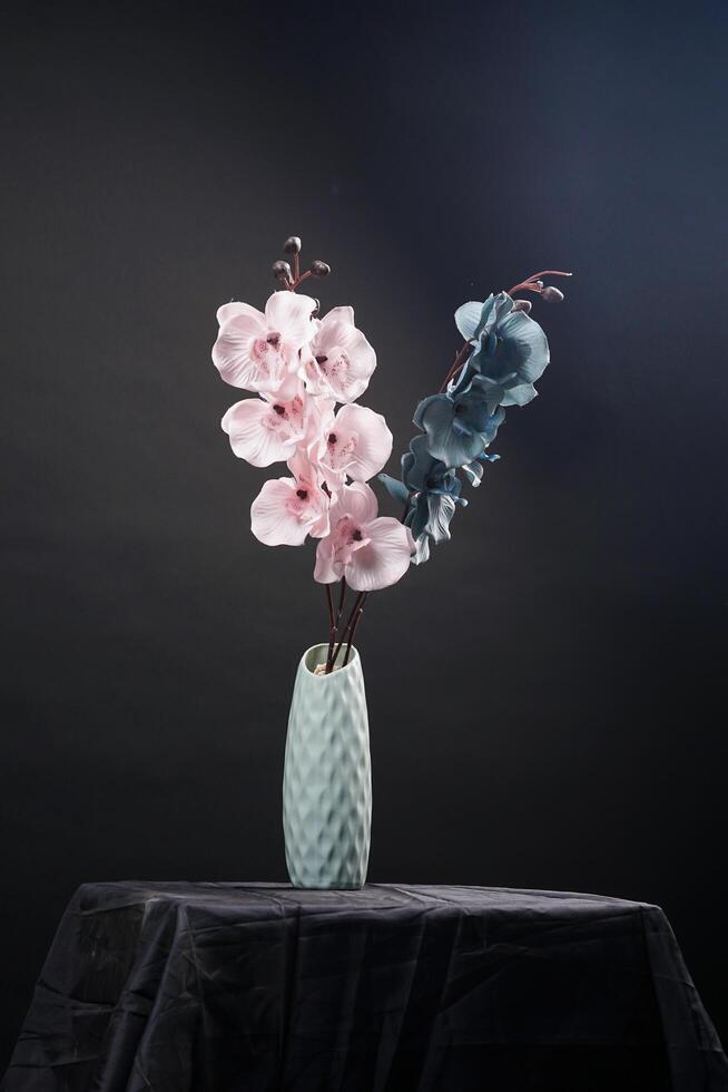 Pink and grey spring flowers in a vase on black background. High resolution photo. Selective focus. photo