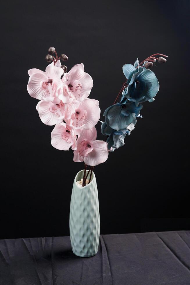 Pink and grey spring flowers in a vase on black background. High resolution photo. Selective focus. photo