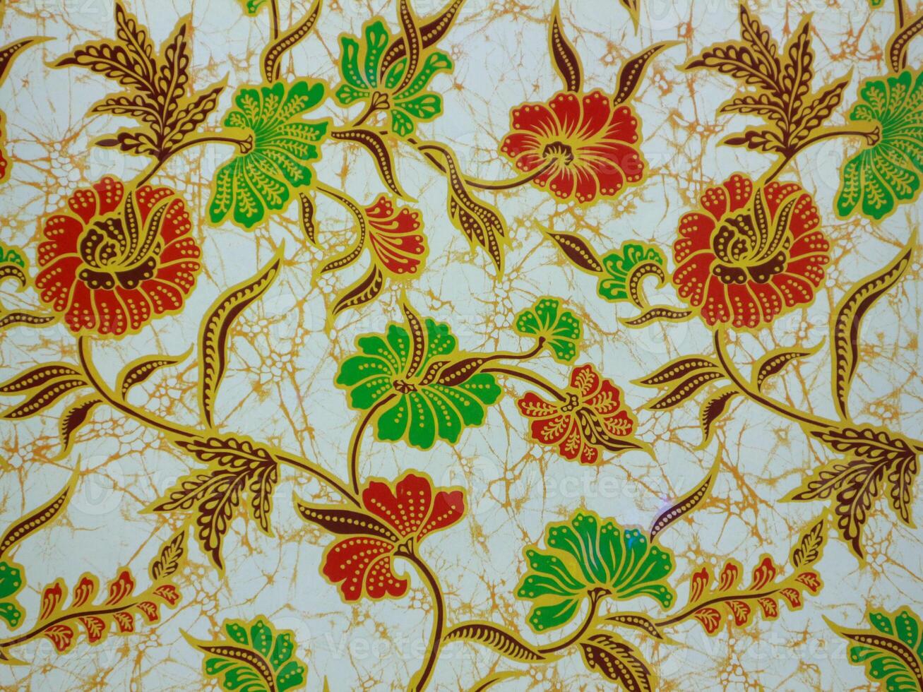 The beautiful red and green of art Indonesian Batik with leaf and flowers pattern fabric photo
