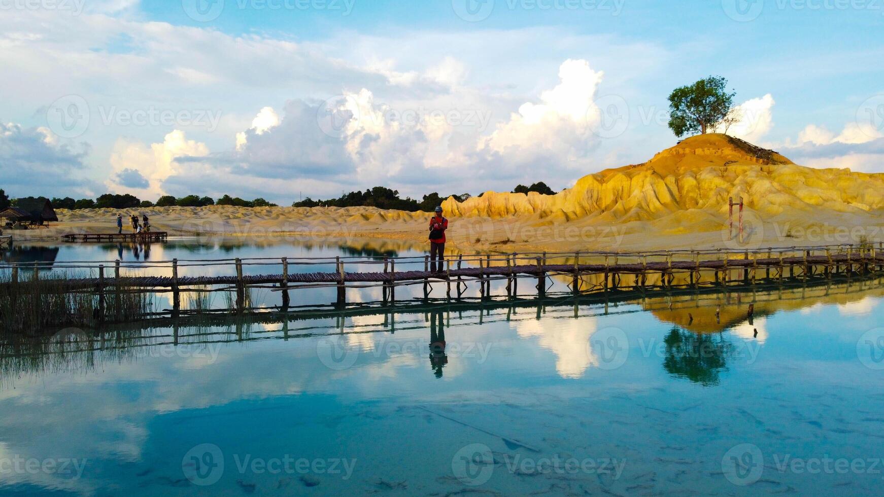 Bintan Blue Lake in Tanjung Pinang captivates with its stunning hues and soft white sand mounds. The vibrant colors of the water create a picturesque landscape photo