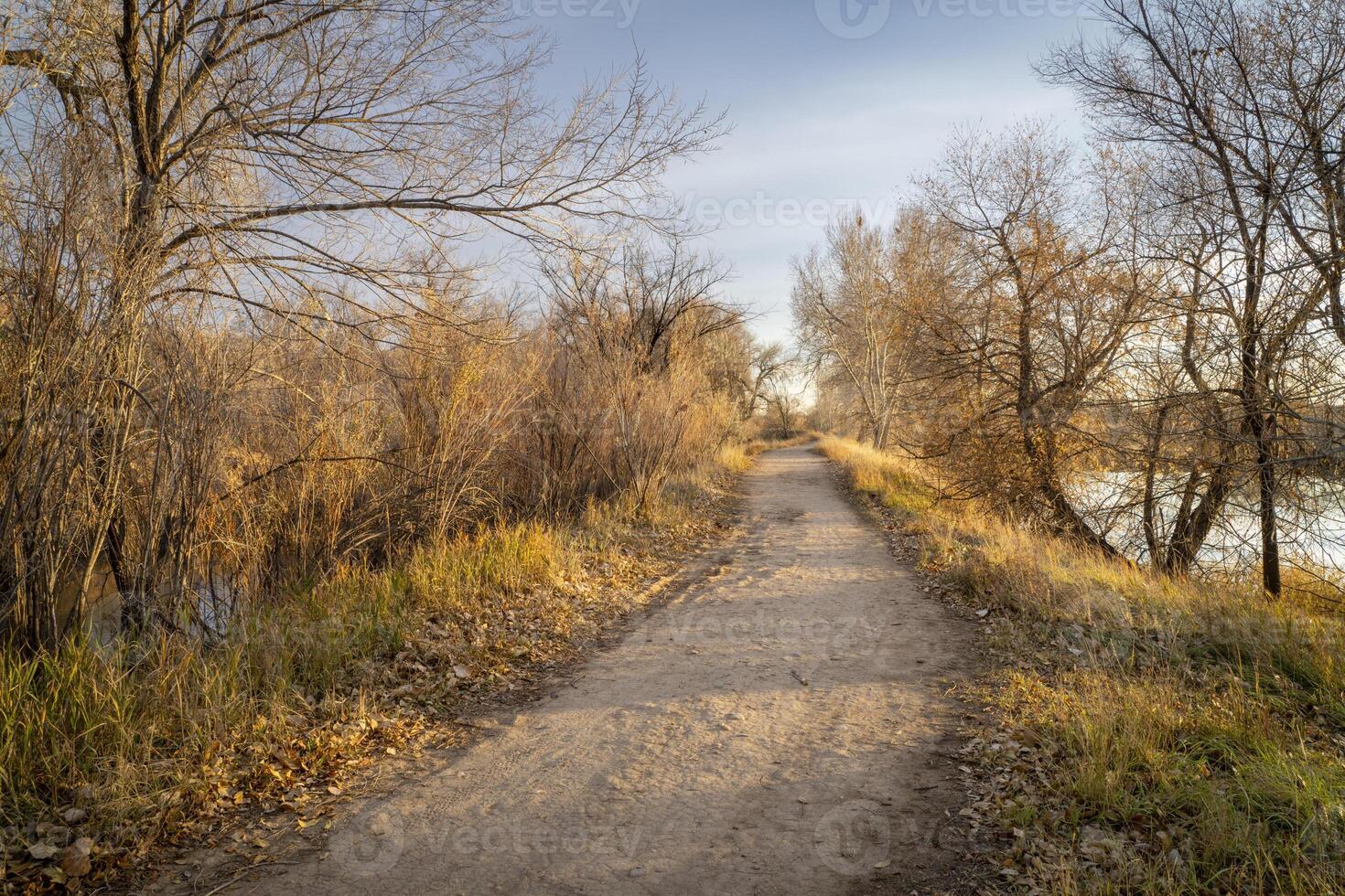 gravel hiking and biking trail in late fall scenery in one of natural areas in Fort Collin, Colorado photo