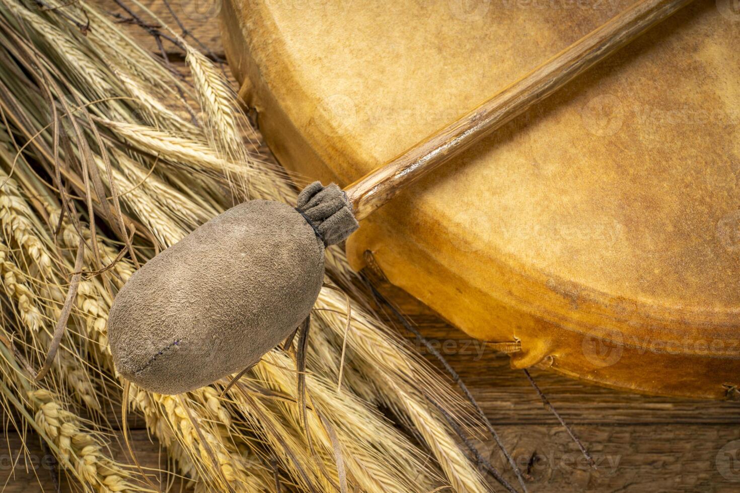 handmade, native American style, shaman frame drum with a beater and dried grain stalks photo
