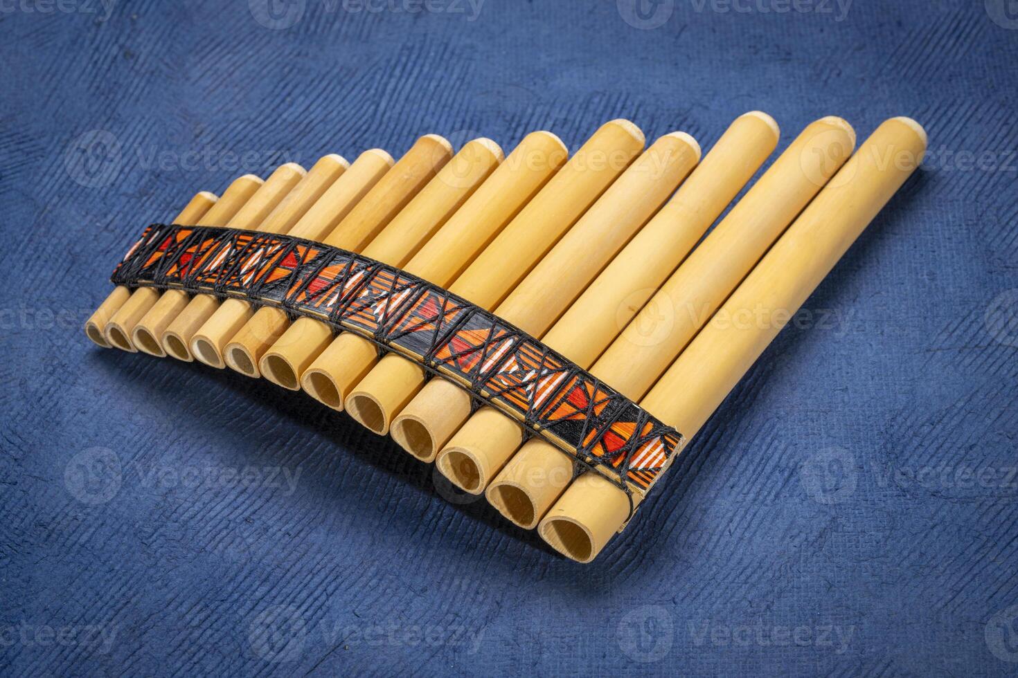 bamboo pan flute instrument from Peru against textured art paper photo