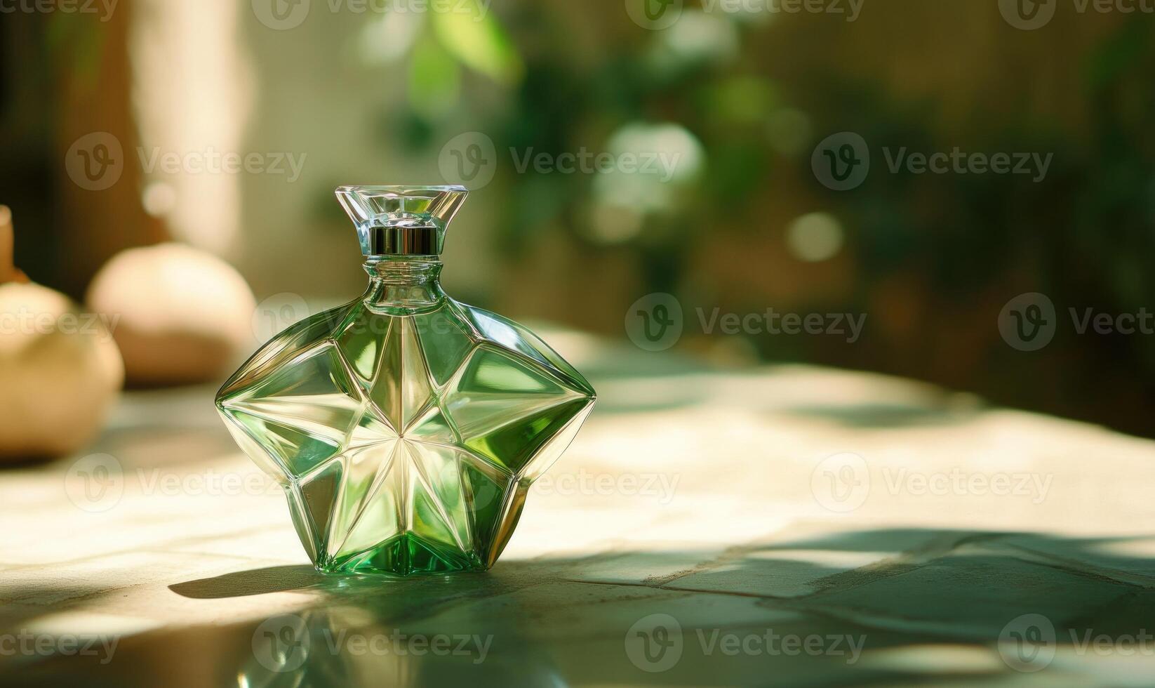 A green bottle of perfume is sitting on a table photo